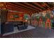 Outdoor patio seating area with fire pit and wood plank patio at 4574 Picutis Rd, Indian Hills, CO 80454
