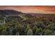 Sunset aerial view shows mountain landscapes and a forest of trees at 4574 Picutis Rd, Indian Hills, CO 80454