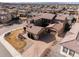 An aerial view showcasing a home with a tile roof, paver driveway, and well manicured landscaping at 9355 E Winding Hill Ave, Lone Tree, CO 80124