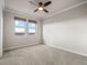 Empty, bright room with two view windows and modern ceiling fan at 9355 E Winding Hill Ave, Lone Tree, CO 80124