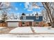 Attractive two-story home with brick and blue siding, attached garage, and snowy front yard at 502 E Lake Ave, Centennial, CO 80121