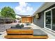 Large back patio area with custom seating, tv, outdoor grill, and partially covered with shade at 1440 S Clermont St, Denver, CO 80222