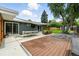 Relax or dine in this large back patio, featuring a sleek shade, wood deck, and luscious yard at 1440 S Clermont St, Denver, CO 80222