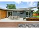 Enjoy outdoor living on this patio with a unique shade structure, lounge area, and dining space at 1440 S Clermont St, Denver, CO 80222