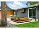 Backyard patio with a shade feature, outdoor television, and comfortable outdoor seating space at 1440 S Clermont St, Denver, CO 80222