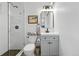 Updated bathroom with modern fixtures, glass shower, and gray vanity at 1440 S Clermont St, Denver, CO 80222