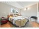 Cozy bedroom with neutral walls, hardwood floors and large window at 1440 S Clermont St, Denver, CO 80222