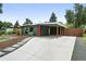Stylish single-story home with a spacious driveway and covered carport, perfect for easy parking at 1440 S Clermont St, Denver, CO 80222