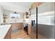 Well-lit kitchen with wood cabinets, stainless steel appliances, and a white countertop at 1440 S Clermont St, Denver, CO 80222