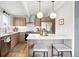 Modern kitchen featuring updated cabinets, stainless steel appliances, and a breakfast bar at 1440 S Clermont St, Denver, CO 80222