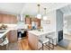 Updated kitchen featuring modern appliances, an eat-in island, and gas range at 1440 S Clermont St, Denver, CO 80222