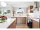 Well-lit kitchen with updated appliances, modern cabinetry, and stylish backsplash at 1440 S Clermont St, Denver, CO 80222