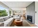 Inviting living room with a cozy fireplace and views through expansive windows at 1440 S Clermont St, Denver, CO 80222