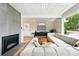 Modern living room featuring a fireplace, ample seating, and updated decor at 1440 S Clermont St, Denver, CO 80222