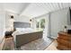 A naturally lit main bedroom showcases a sliding glass door and a decorative rug at 1440 S Clermont St, Denver, CO 80222