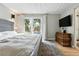 Main bedroom with a wooden dresser and sliding glass door overlooking backyard patio at 1440 S Clermont St, Denver, CO 80222