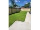A well-manicured lawn complements this residence's outdoor space, framed by a pristine wooden fence and concrete patio at 4835 Grove St, Denver, CO 80221