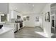 Bright kitchen features stainless appliances, stone countertops and easy access to the entry door at 4835 Grove St, Denver, CO 80221