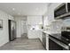 Modern kitchen features white cabinets, stainless appliances and easy access to dining and additional living space at 4835 Grove St, Denver, CO 80221