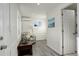 Bright living room with wood floors, mini split unit, and fresh white paint at 4835 Grove St, Denver, CO 80221