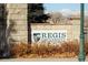 Landscaped brick sign for Regis University with a stone wall and foliage at 4835 Grove St, Denver, CO 80221