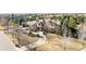 Beautiful aerial view of the home with a long drive, surrounded by well-maintained landscaping and mature trees at 4041 E Forbes Ct, Greenwood Village, CO 80121