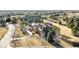 Bird's eye view of the property nestled among mature trees, featuring a circular driveway and lush landscaping at 4041 E Forbes Ct, Greenwood Village, CO 80121