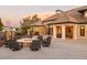 Inviting backyard featuring a stone fire pit with ample seating and a covered outdoor dining area perfect for entertaining at 4041 E Forbes Ct, Greenwood Village, CO 80121