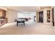 Large basement with a ping pong table, gym equipment, a kitchenette, and plenty of natural light at 4041 E Forbes Ct, Greenwood Village, CO 80121