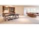 Basement with a ping pong table, kitchenette, and large seating area with comfortable couches at 4041 E Forbes Ct, Greenwood Village, CO 80121