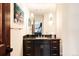 Modern bathroom with dark wood vanity, granite countertop, and stylish lighting at 4041 E Forbes Ct, Greenwood Village, CO 80121