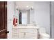 Bright bathroom featuring a white vanity with marble countertops, a modern mirror, and neutral wall color at 4041 E Forbes Ct, Greenwood Village, CO 80121