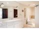 Spacious bathroom featuring a double vanity, marble countertops, and a separate tub with stone surround at 4041 E Forbes Ct, Greenwood Village, CO 80121