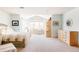 Bright bedroom with a sitting area, a large window, and wooden dresser at 4041 E Forbes Ct, Greenwood Village, CO 80121