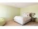 Relaxing bedroom featuring a queen-sized bed with decorative pillows, neutral carpet, and a light green wall color at 4041 E Forbes Ct, Greenwood Village, CO 80121