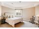Neutral bedroom featuring a queen bed with stylish pillows and minimalist decor, creating a cozy and serene atmosphere at 4041 E Forbes Ct, Greenwood Village, CO 80121