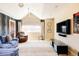 Comfortable bonus room with a vaulted ceiling, large window, and media center at 4041 E Forbes Ct, Greenwood Village, CO 80121