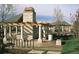 Stylish outdoor community amenity with stone pillars, pergola, bike rack, bench and manicured landscaping, perfect for leisure and recreation at 4041 E Forbes Ct, Greenwood Village, CO 80121