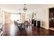 Formal dining room with hardwood floors, classic wainscoting, chandelier lighting, and ample seating for entertaining at 4041 E Forbes Ct, Greenwood Village, CO 80121