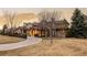Charming exterior elevation showcasing the beautiful landscaping, large windows, and well-maintained lawn at 4041 E Forbes Ct, Greenwood Village, CO 80121