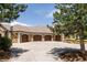 Attached four-car garage with stylish wood doors, a basketball hoop, and a spacious driveway at 4041 E Forbes Ct, Greenwood Village, CO 80121