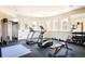 Home gym featuring modern exercise equipment, rubber flooring, and natural light from the windows at 4041 E Forbes Ct, Greenwood Village, CO 80121