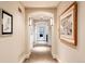 Inviting hallway with arched doorways, decorative lighting, and elegant carpet at 4041 E Forbes Ct, Greenwood Village, CO 80121