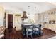 Kitchen with a large center island, custom cabinets, granite countertops, stainless appliances, and pendant lighting at 4041 E Forbes Ct, Greenwood Village, CO 80121