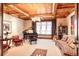 Elegant living room featuring a grand piano, coffered ceiling, and ample natural light at 4041 E Forbes Ct, Greenwood Village, CO 80121