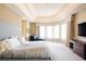 Serene main bedroom with ambient lighting, curved bay window, light color palette, and plush carpeting at 4041 E Forbes Ct, Greenwood Village, CO 80121