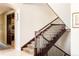 Beautiful staircase with decorative carpet runner, wood railing, and iron balusters at 4041 E Forbes Ct, Greenwood Village, CO 80121