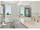 Bathroom with dual vanity, modern fixtures, and a glass-enclosed shower at 11475 E Briarwood Cir, Centennial, CO 80112