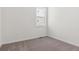 Small, empty bedroom with neutral carpeting and a single window at 11475 E Briarwood Cir, Centennial, CO 80112