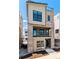 Modern three-story home featuring a brick facade and a second-story balcony at 11475 E Briarwood Cir, Centennial, CO 80112
